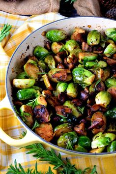 brussel sprouts and mushrooms in a skillet on a yellow checkered tablecloth