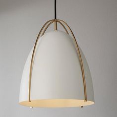 a white and gold pendant light hanging from a ceiling in a living room or kitchen