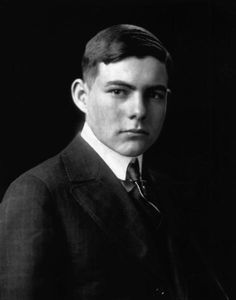 an old black and white photo of a young man in a suit with a tie