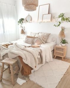 a bedroom with white walls and wooden flooring is decorated in neutral tones, including wicker furniture