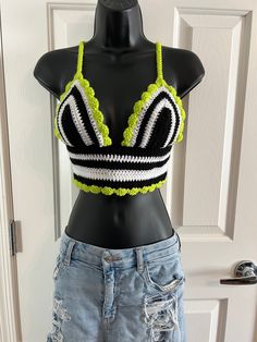 🖤🤍 BEETLEJUICE, BEETLEJUICE...it's SHOWTIME! 🤍🖤 Be a strange and unusual in this perfect Beetlejuice inspired black, white and lime green crochet crop top. The perfect outfit to read the Handbook for the Recently Deceased.  Jam out and dance to the Banana Song in this amazing Beetlejuice crocheted shirt that you will most definitely stand out in a crowd!  Perfect for a summer music festival, farmers market, concert, food festival or just a stunning piece for the boho style. Not to mention the BEST SHIRT to watch the original or the newest movie!  Shirt is not lined but tight crochet pattern allows for little to no show through. Such a gorgeous, one of a kind shirt! The Beetlejuice fan can make a huge statement with this piece of fashion!  Criss-Cross tie is single crocheted for a comfo Beetlejuice Crochet Top, White Fitted Top For Costume Party, Fitted Black Crochet V-neck Top, Fitted Black V-neck Crochet Top, Fitted Rave Tops For The Beach, Fitted Rave Tops For Beach, Fitted Black Crop Top For Cosplay, Black Top For Spring Cosplay, Spring Black Top For Cosplay