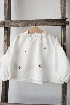 Exclusive meadow parachute tunic shirt with long puff sleeves and ruffled neckline is made of 100% soft medium weight linen.  Details: - Choose size in the drop down menu - Colour: White - Composition: 100% Oeko-Tex certified linen - Embroidered hedgehog, ladybug, blueberry, leaf, wild strawberry, clover & bee (front and back) - Ruffled sleeves - Ruffled neckline  - Medium weight linen - Linen care: machine wash gentle; tumble dry low, ironing optional - The price is for one tunic, other picture Spring Embroidered Long Sleeve Top With Ruffles, Embroidered Spring Tops With Ruffled Collar, Fall Smock Top With Balloon Sleeves, Fall Smock Tops With Balloon Sleeves, Long Sleeve Cotton Embroidered Top, Embroidered Puff Sleeve Tops For Fall, White Peasant Top With Smocked Cuffs And Long Sleeves, White Long Sleeve Peasant Top With Smocked Cuffs, White Balloon Sleeve Top With Smocked Cuffs