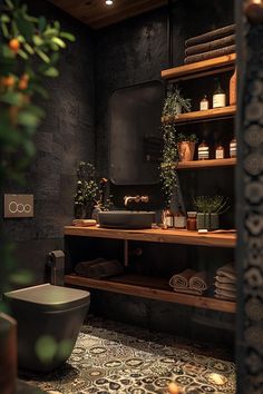 the bathroom is decorated in black and features an intricately designed sink, shelving with potted plants