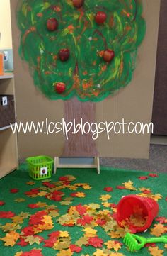 an apple tree made out of leaves on the floor in front of a classroom door