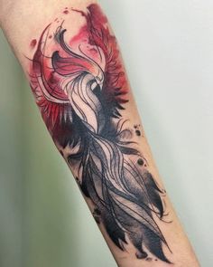 a woman's arm with a bird tattoo on it