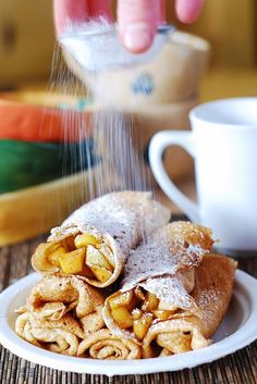 some food is on a white plate and sprinkled with sugar