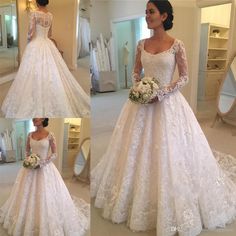 a woman wearing a wedding dress with long sleeves and flowers on the skirt is standing in front of a mirror