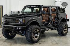 a large black truck with brown leather seats on it's front wheels and tires