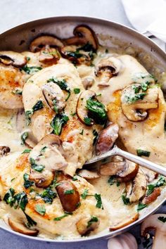 a pan filled with chicken and mushrooms covered in gravy