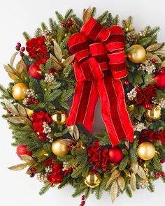 a christmas wreath with red and gold decorations