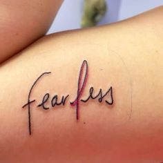 a woman's arm with the word fearless written in cursive writing on it