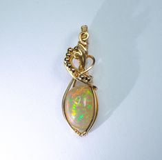 Unique 14k Gold Wire Wrapped Jewelry, Unique Opal Wire Wrapped Jewelry, Gold Ethiopian Opal Jewelry For Gift, Handmade Yellow Gold Jewelry With Ethiopian Opal, Gold Ethiopian Opal Cabochon Jewelry, Unique Gold Opal Jewelry, Cloak Of Invisibility, Moldavite Stone, Dreams And Nightmares