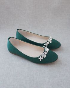 the bride's green shoes are adorned with crystal flowers