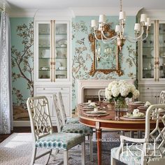 an elegant dining room with blue and white wallpaper