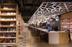 the interior of a book store with rows of books on shelves and desks in front of them