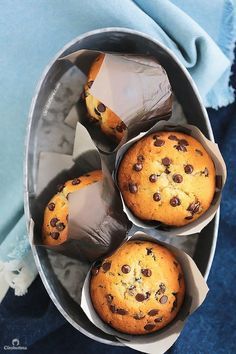 three chocolate chip muffins in paper containers