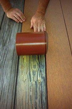 a person is rolling down a wooden floor with a roll of tape