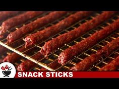 several skewered meats on a grill with the words snack sticks above them