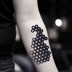 a black and white tattoo on the arm