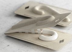 a pair of scissors sitting on top of a piece of paper next to each other