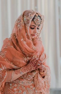 a woman in an orange and gold wedding outfit