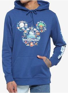 a man wearing a blue hoodie with mickey mouse's castle printed on it