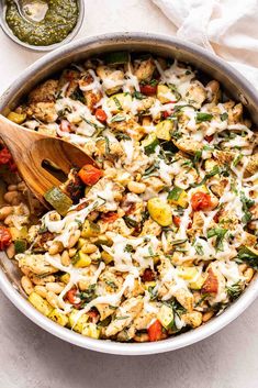 a skillet filled with pasta and vegetables