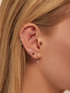 a close up of a person with ear piercings on their left and right ears