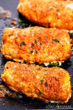 two cooked fish fillets sitting on top of a grilling pan with parsley