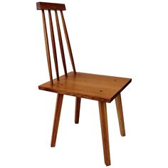 a wooden chair sitting on top of a white floor