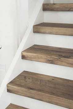 the stairs are made of wood and have glass balconies