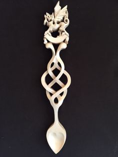 a white spoon with a dragon on it