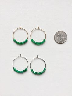 Emerald Hoop Earrings. Ten faceted emeralds adorn each hoop for a total of 20 emeralds in these beautiful earrings! These are perfect with jeans and a t-shirt or to wear with your best outfit! The hoops measure 1-1/4 inches in length and width or just over 3 cm. These earrings are available in either gold plated or rhodium plated finish. Emerald is the May birthstone. Your emerald hoop earrings will arrive gift boxed. If this is a gift, I would be glad to include a card with your personal messag Small Hoop Earrings With Faceted Beads For Gift, Small Hoop Jewelry With Faceted Beads For Gifts, Faceted Hoop Earrings As Gift, Gift Hoop Earrings With Faceted Beads, Faceted Beads Dangle Hoop Earrings For Gifts, Earrings Gold Hoop, Earrings Emerald, Hoop Earrings Silver, Hoop Earrings Gold