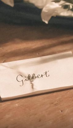 a piece of paper with the word clement written on it sitting on a wooden table