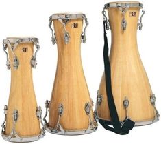 three wooden congs with silver hardware and straps