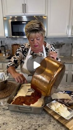 a woman is making food in her kitchen