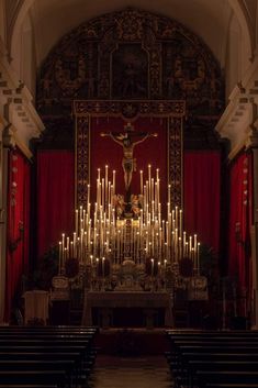 the interior of a church with candles lit