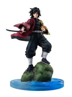 an action figure is posed on top of a rock