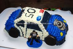 a cake made to look like a police car with a toy figure on the side