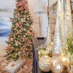 a christmas tree is decorated with gold and silver ornaments, as well as other holiday decorations