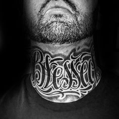 a man with tattoos on his neck and chest