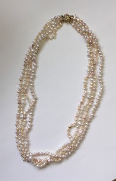 "Four strands of biwa fresh water pearls with a 14 karat yellow gold clasp and bead tips.  All stands are knotted.  Finished length is 22\".  Pearls range from 4 mm to 5.5 mm.  All natural colors." Multi-strand Gold Pearl Chain Jewelry, Multi-strand Pearl Necklace With Pearl Charm, Multi-strand Pearl Necklaces With Pearl Charm, Multi-strand Pearl Drop Necklace, Handmade Gold Multi-strand Pearl Necklace, Gold Multi-strand Necklace With Pearl Pendant, Gold Multi-strand Pearl Necklace, Bead Tips, Biwa Pearls