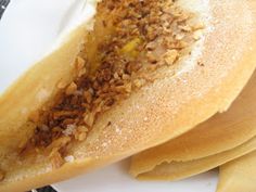 a plate with some pancakes on it and other food items in front of it,