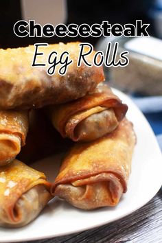 an egg roll on a white plate with cheesesteak in the middle and text overlay