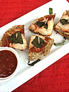 four pieces of pizza on a plate with dipping sauce