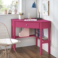 a pink desk and chair in a room