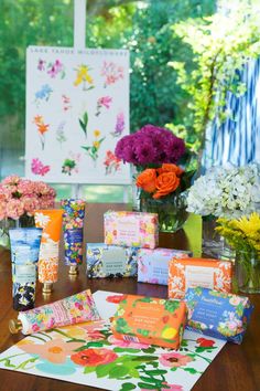 the flowers are in vases and on the table next to each other, all wrapped up with different types of wrapping paper