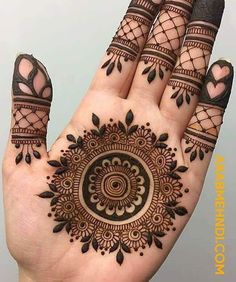 a hand with henna tattoos on it