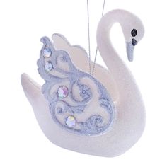 a white swan ornament hanging from a chain with swaroes on it's neck