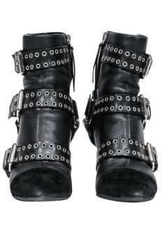 Unleash your inner rocker chick in these over-the-top booties from Isabel Marant. Buckles with grommets and studs adorn these edgy boots. Perfect for your next concert! Pair with distressed jeans and a leather jacket and you'll be sure to be invited on stage! Size 5.5 (FR 37) Leather upper w/ suede trim Buckled design w/ grommets and studs Interior side zipper closure Pointed toe Chunky heel Leather sole and footbed w/ very minor wear Heel 3.5" Edgy Boots, Isabel Marant Shoes, Rocker Chick, Buy Shoes Online, Black Leather Heels, Chunky Heel, Biker Boot, On Stage, Isabel Marant